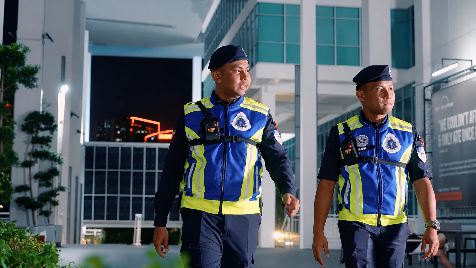 Auxiliary police officers on nighttime campus security patrol wearing Motorola VB400 body-worn cameras
