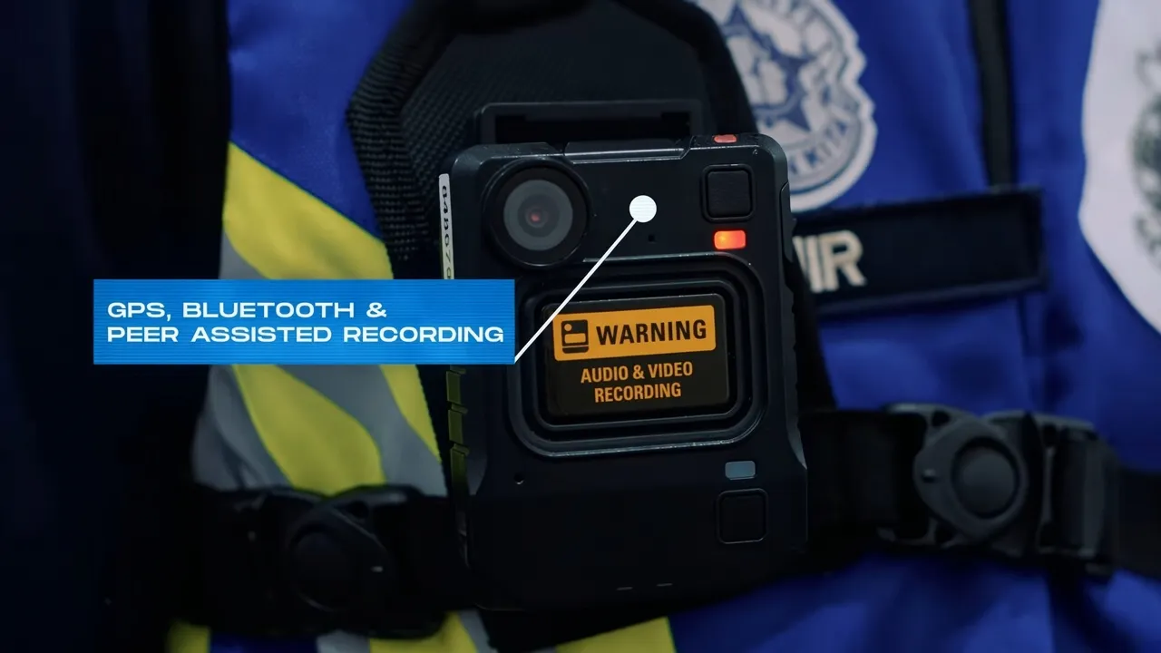 Motorola Solutions VB400 body-worn camera mounted on security uniform showing GPS, Bluetooth and peer-assisted recording features